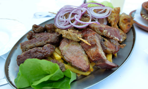 istock Various grilled meat on a metal plate on the table in the restaurant 1055470654