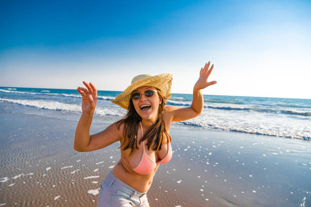 Woman is dancing and singining on the sea