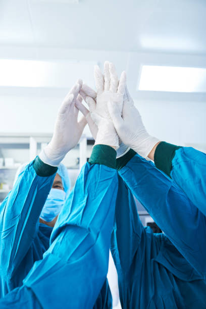 istock Unrecognizable surgeons high-fiving before surgery 1055470738