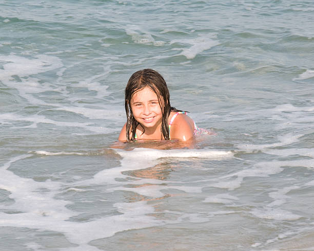 Young Hispanic girl playing at the beach