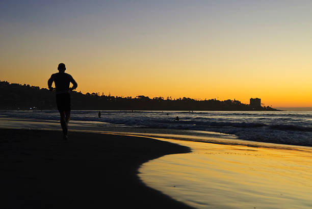 istock Man running on a San Diego beach at sunset 105547355