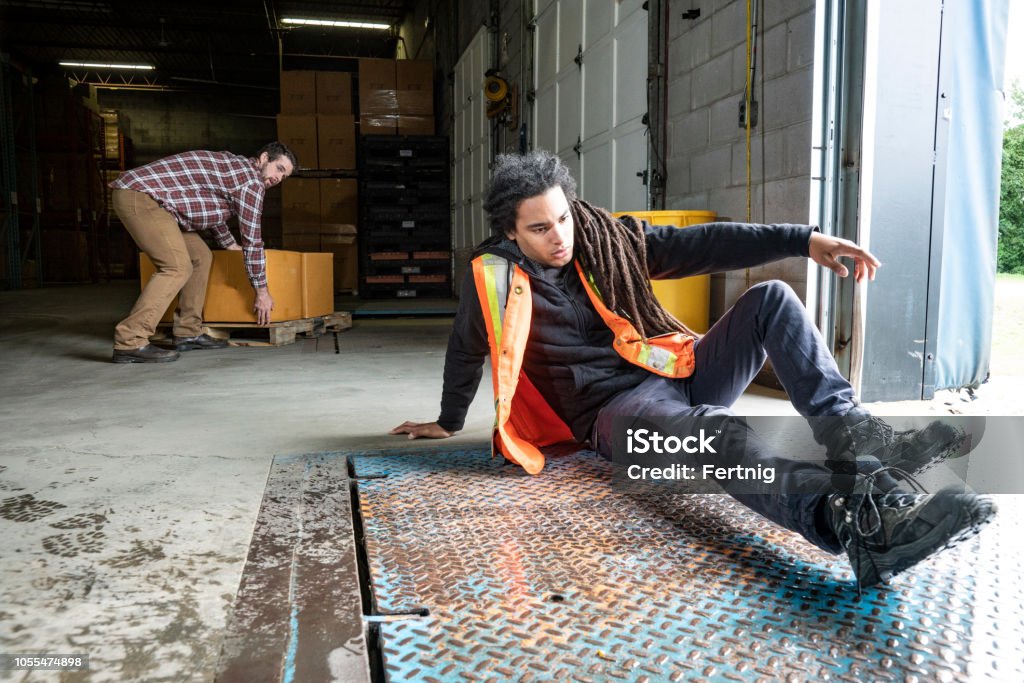 A Warehouse Worker Tripping And Falling On A Loading Dock Stock Photo ...
