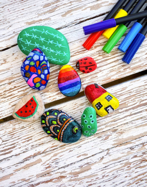 istock Hand-painted colorful stones and pens 1055475690