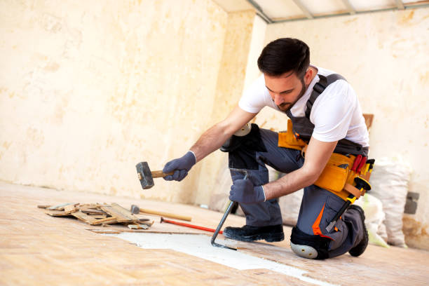istock Crafty handyman removing old parquet 1055476854