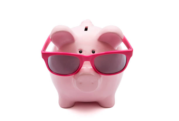 istock Piggy bank with pink glasses on white background 1055477832