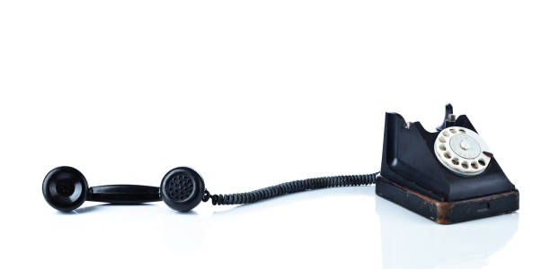 istock Old black phone isolated on  white. 1055484668