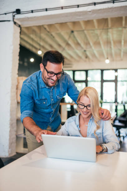 istock Smiling young colleagues working together in bright modern office. 1055485546