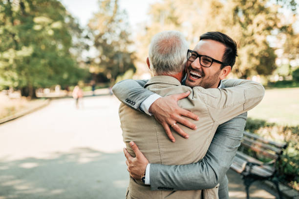Family reunion. Father and son hugging outdoors. Family reunion. Father and son hugging outdoors. reunion stock pictures, royalty-free photos & images