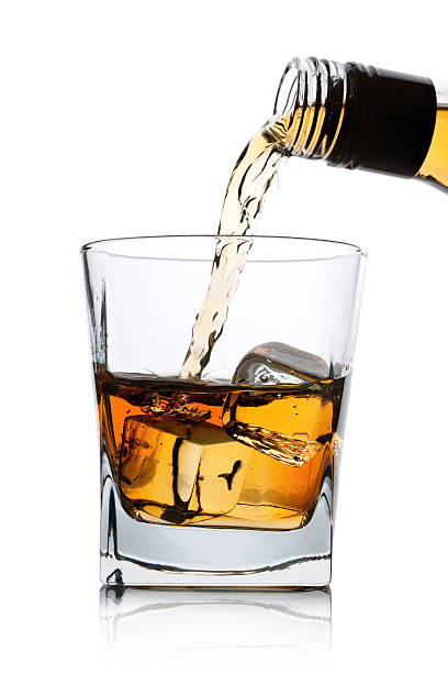 istock Whiskey being poured into glass cup with ice 105548629