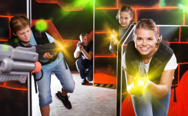 Photo of Woman playing lasertag with family