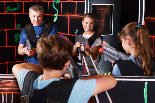 istock Kids and adults playing lasertag 1055486944