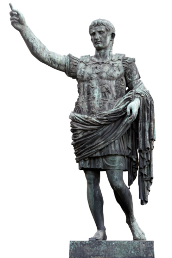 A detailed view of the bronze statue of the Emperor Gaius Iulius Caesar Augustus, also know as Octavian or Augustus, along the Viale dei Fori Imperiali (Avenue of the Imperial Forums), in the ancient heart of Rome. This bronze statue, placed in front of the Forum of Augustus, is a copy of the marble original currently preserved in the Vatican Museums. Caesar Augustus was the first Roman emperor, revered as father of the homeland (Patri Patriae) and artecife of a long period of domination, prosperity and peace throughout the empire, known as Pax Romana or Pax Augustea. The Roman Forum, one of the largest archaeological areas in the world, represented the political, legal, religious and economic center of the city of Rome, as well as the nerve center of the entire Roman civilization. In 1980 the historic center of Rome was declared a World Heritage Site by Unesco. Image in original 4:3 ratio and high definition quality.