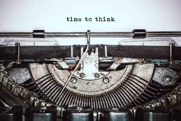 istock Retro vintage typewriter writes text on old white paper. 1055494552