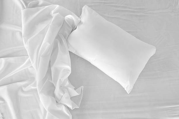 Bird's eye view of a white, unmade bed Top view of an unattended bed. bedding stock pictures, royalty-free photos & images