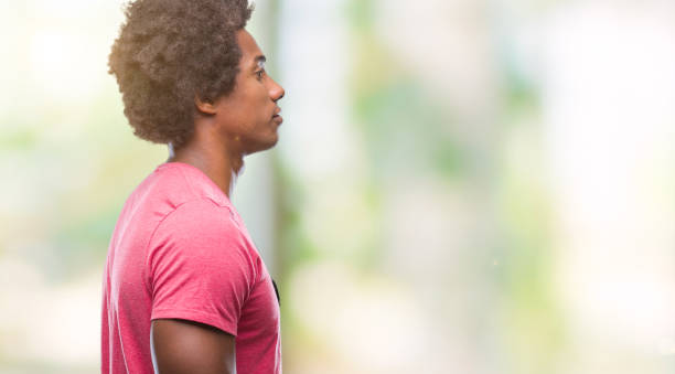 istock Afro american man over isolated background looking to side, relax profile pose with natural face with confident smile. 1055502342