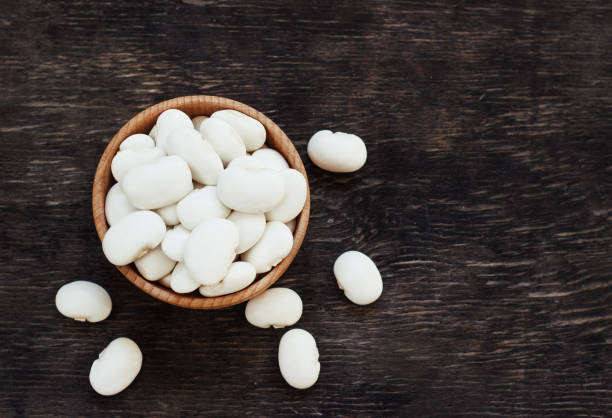 istock white beans on a dark wooden background in a cup 1055504710