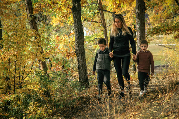 istock Mother with son in forest in autumn 1055506302