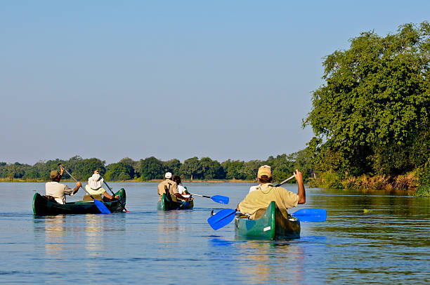 Two women having fun on a canoe .
