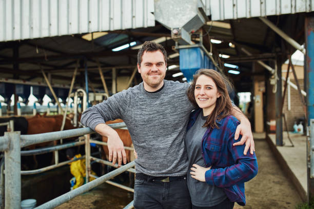 Dairy is our passion Portrait of a happy young couple working on a dairy farm the farmer and his wife pictures stock pictures, royalty-free photos & images