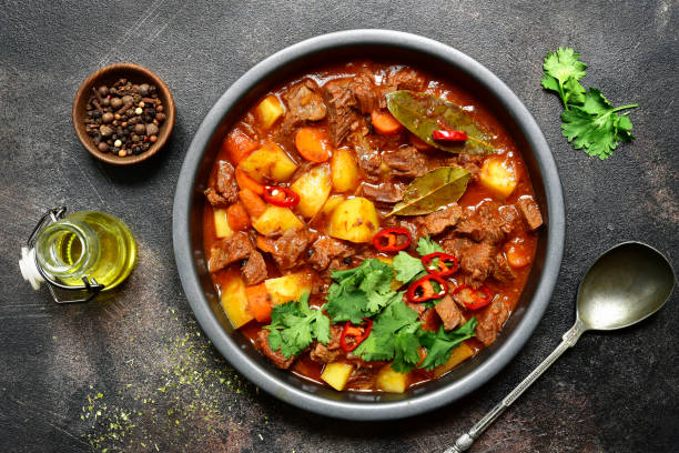 istock Meat stewed with vegetables in tomato sauce (hungarian goulash) 1055520090