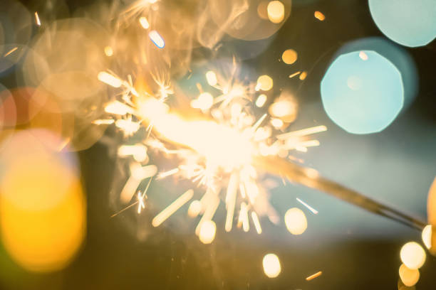 istock Sparkler Bokeh Colorful sparkler. Night background with a sparkler. 1055521278
