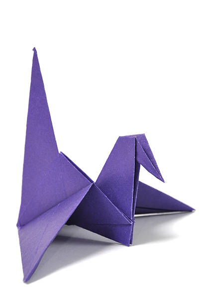 istock Purple origami crane on a blank background 105552377