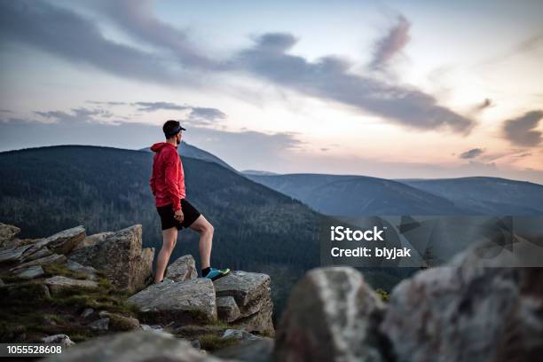 Man Celebrating Sunset Looking At View In Mountains Stock Photo - Download Image Now