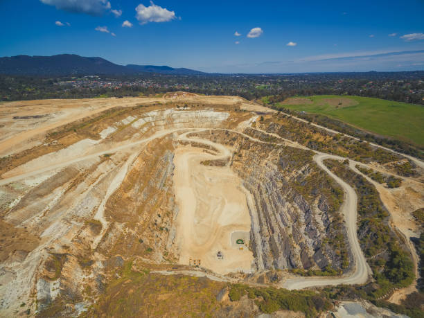 istock Aerial view of closed mine pit and mountains 1055529384