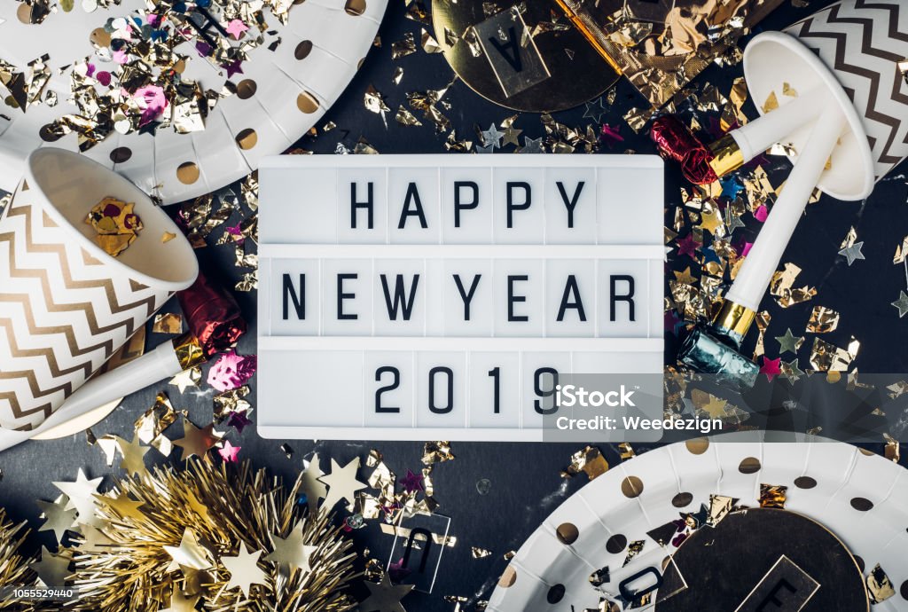Happy new year 2019 on light box with party cup,party blower,tinsel,confetti.Fun Celebrate holiday party time table top view. Happy new year 2019 on light box with party cup,party blower,tinsel,confetti.Fun Celebrate holiday party time table top view New Year Stock Photo