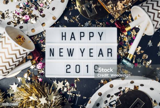 Happy New Year 2019 On Light Box With Party Cupparty Blowertinselconfettifun Celebrate Holiday Party Time Table Top View Stock Photo - Download Image Now