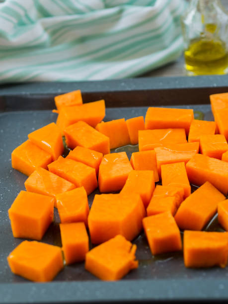 istock Chopped pumpkin drizzled with oil for baking 1055529720