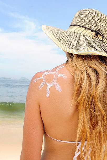 istock woman with suntan lotion at the beach 105553139