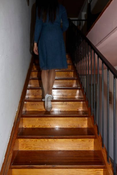 istock Legs downstairs with bright shoes 1055531544
