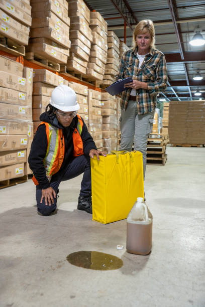 istock Checking for MSDS information on a spilled liquid in an industrial warehouse. 1055534066
