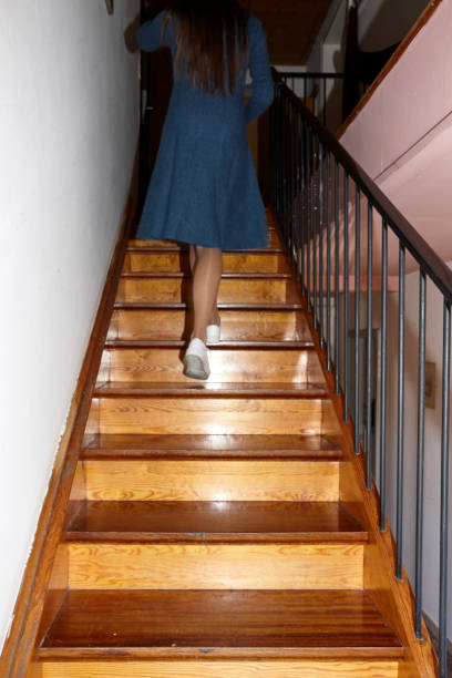 istock Legs upstairs with white shoes 1055534486