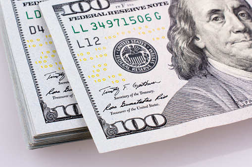 American 100 dollar  banknotes made of paper placed on white background