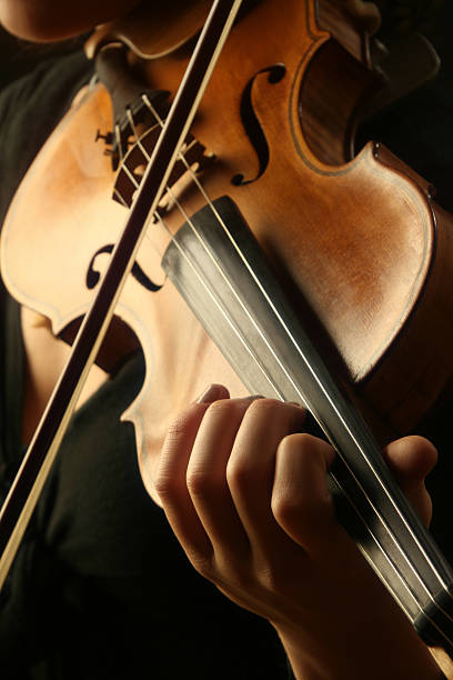 Violin playing  chamber orchestra stock pictures, royalty-free photos & images