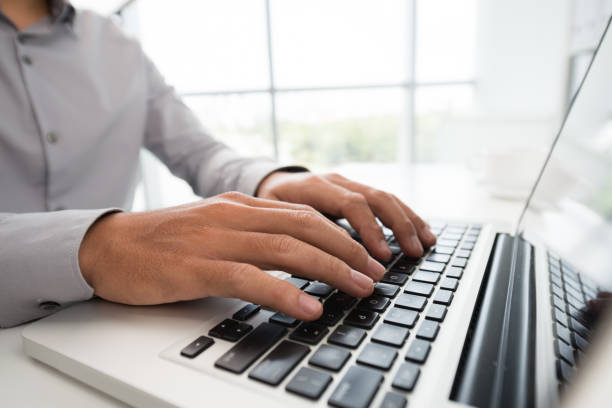 istock Crop man working on laptop in daylight 1055542016