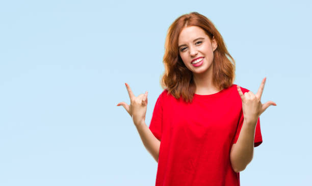 istock Young beautiful woman over isolated background shouting with crazy expression doing rock symbol with hands up. Music star. Heavy concept. 1055544222