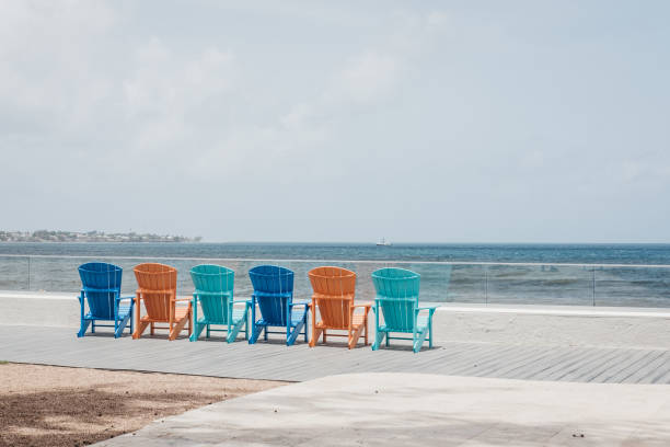 istock Colourful deck chairs arranged in a row by the sea. 1055544538