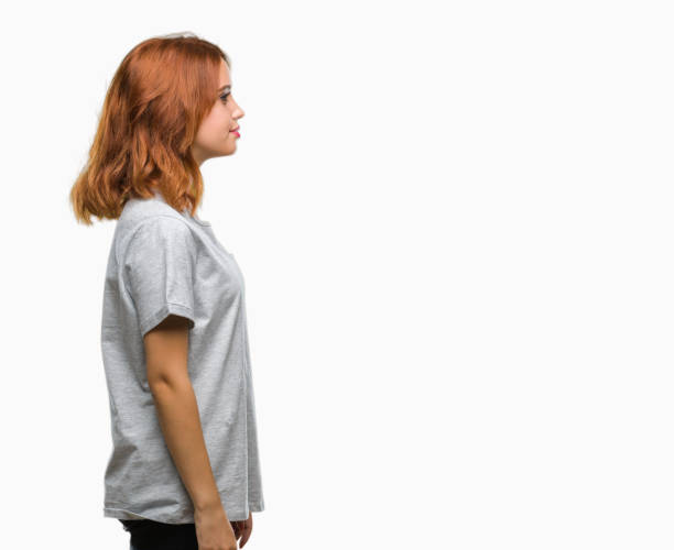 istock Young beautiful woman over isolated background looking to side, relax profile pose with natural face with confident smile. 1055544686