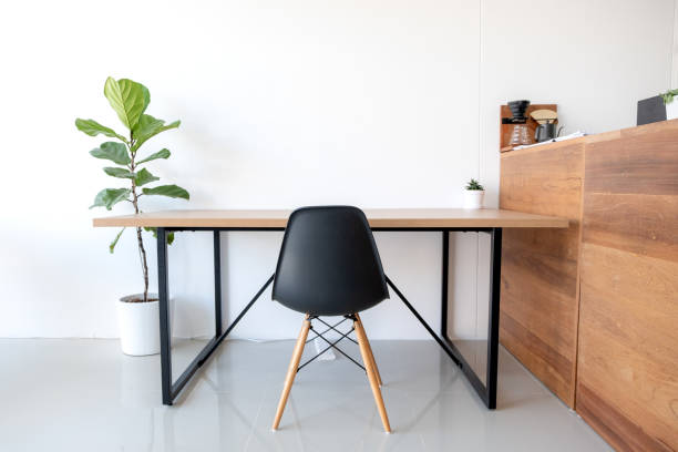 istock Wooden tables and chairs with trees decorative in white modern office 1055545826