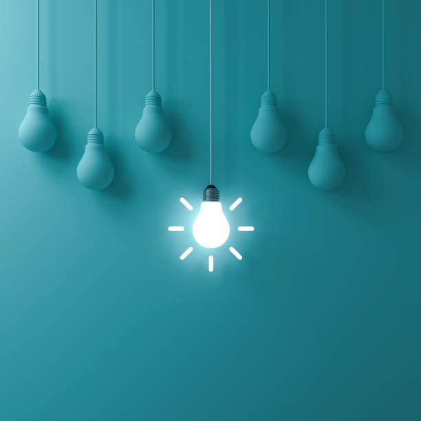 istock Think different concept One hanging glowing idea light bulb standing out from dim unlit bulbs on green pastel color wall background leadership and individuality creative idea concepts 3D rendering 1055546054