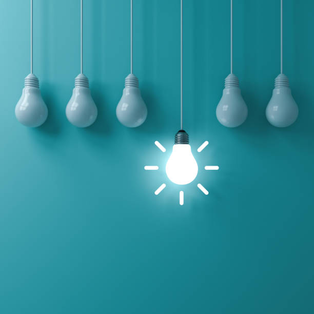istock Think different concept One hanging glowing idea light bulb standing out from dim unlit bulbs on green pastel color wall background leadership and individuality creative idea concepts 3D rendering 1055547200