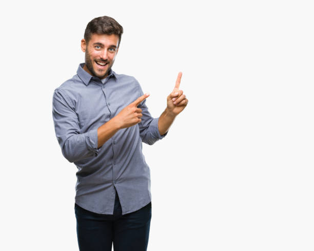 istock Young handsome man over isolated background smiling and looking at the camera pointing with two hands and fingers to the side. 1055547604