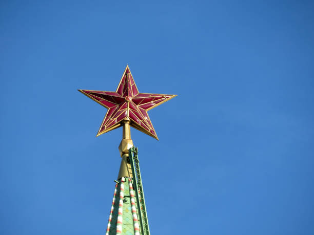 istock Red star on Moscow Kremlin tower isolated on clear blue sky 1055548038