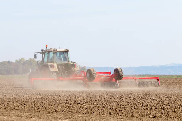 istock Tractor preparing field, Agriculture tractor 1055557682