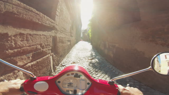 POV scooter riding in Italy: on the motorbike in a narrow alley