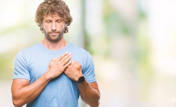 istock Handsome hispanic model man over isolated background smiling with hands on chest with closed eyes and grateful gesture on face. Health concept. 1055558740