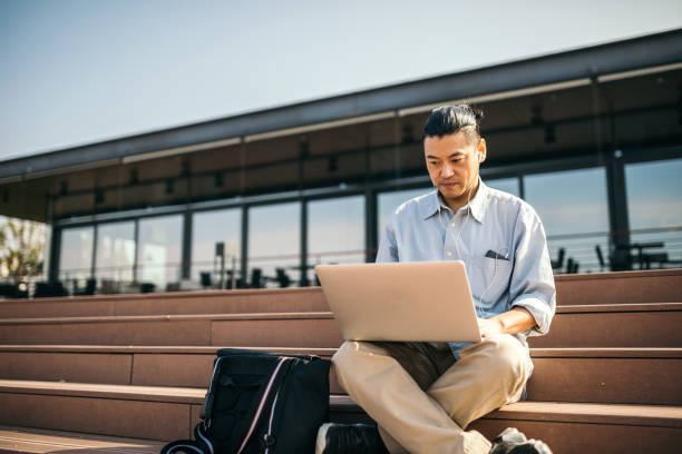 istock Mid adult Japanese is working on laptop 1055559888